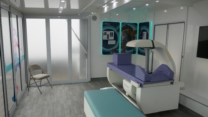 An inside view of the My Vital Metrics mobile unit, showing the DEXA scanner table. 
